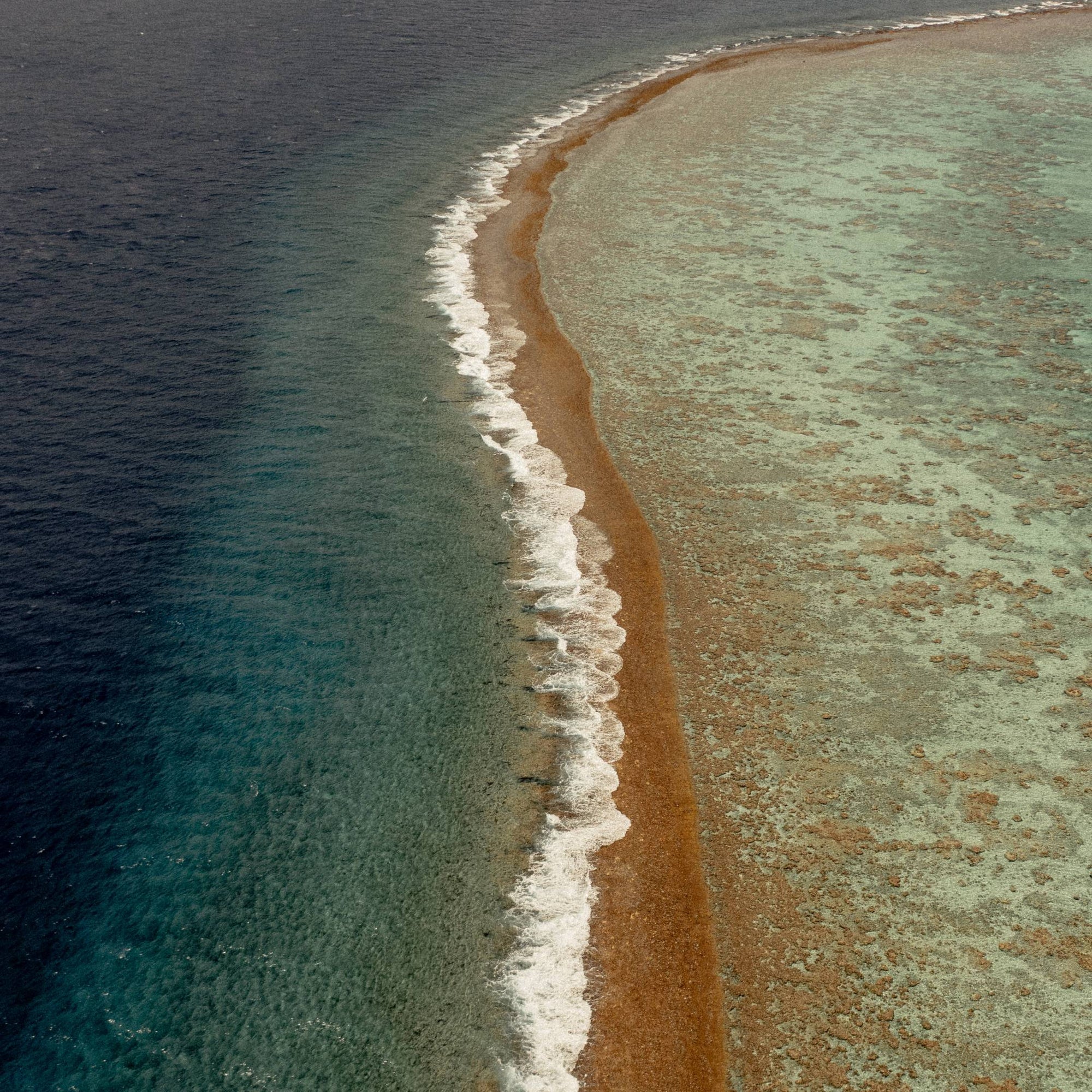Waves hitting the shore in French Polynesia