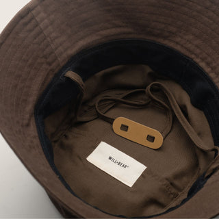 Inside view of the brown string bucket hat showing the label