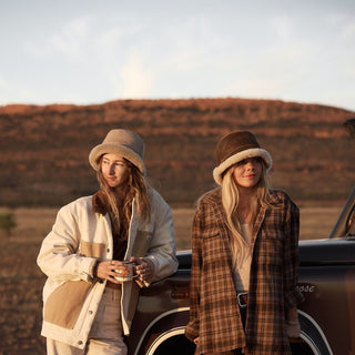 Two women wearing Will & Bear Brown Wool UGG Bucket Hat – Teddy Brown – made for layering, warmth and comfort on chilly adventures.