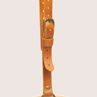 Close-up of tan leather hat holder strap and hardware