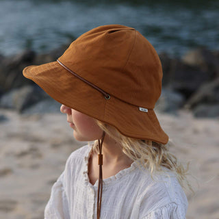 Little girl wearing orange kids bucket hat little lenny rust