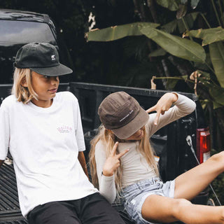 Kids sitting in the back of a ute wearing Little Archie Walnut Kids hat