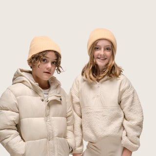 Boy and girl standing side by side wearing Little Bambi Apricot orange knit beanie