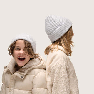 Boy and girl standing back to back wearing Little Bambi Dust Blue Beanie