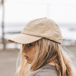Side view of girl wearing Little Riley Gold Baseball cap