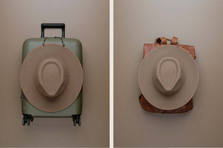 A hat clipped to a suitcase and next to it a hat clipped to a backpack