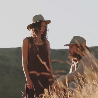 Wide brim flopping hat being worn in nature and indoors