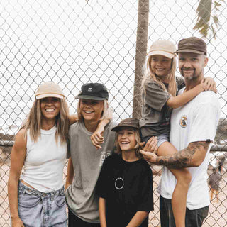 Family wearing baseball caps