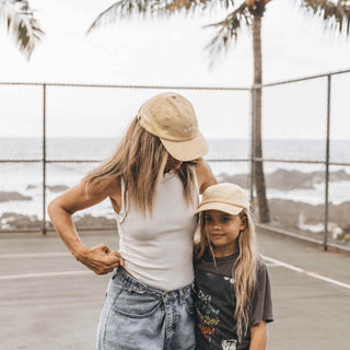 Woman and girl hugging wearing Riley Gold baseball cap