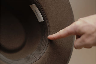 Closeup of the internal of a hat fitted with an adjustable sweatband