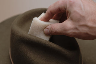 Closeup of a hat sponge cleaning dirt of Will & Bear hat