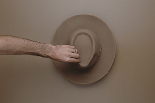 Top down of a person trying on a hat