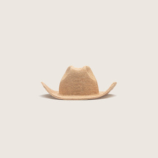 Straw cowboy hat on a light beige background