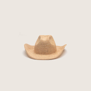 Straw cowboy hat on a light beige background