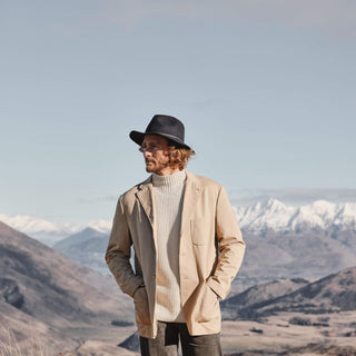 Man styled in Will & Bear Anderson Navy Soft Felt Fedora, rugged and lightweight for travel and nature exploration