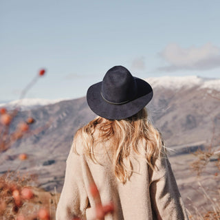 Woman in Will & Bear Anderson Navy Soft Felt Fedora exploring alpine wilderness, built for the outdoors