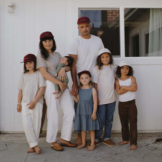 Family wearing Will & Bear Archie Maroon 5-Panel Vintage Cap in matching adventure-ready outfits for the outdoors