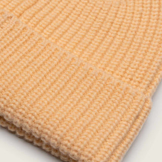 Close-up of the Will & Bear Bambi Apricot beanie showing fine merino wool ribbed knit texture and apricot colour.