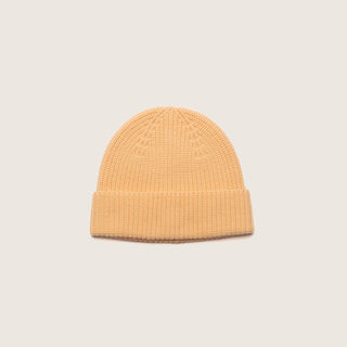 Front-facing view of the Will & Bear Bambi Apricot merino wool beanie highlighting soft structure and fold-over brim.