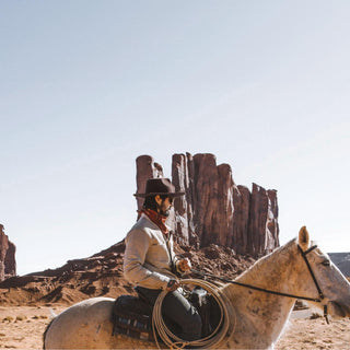Man wearing the Will & Bear Cooper Coffee Brown Western Hat while sitting on a horse in the outback desert landscape.
