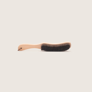 Will & Bear Hat Brush on a neutral background, showing curved wooden handle and natural bristles.