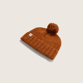 Will & Bear Orange Wool Pom Pom Beanie – Tasman Ochre – angled view showing textured rib knit and soft wool pom pom.