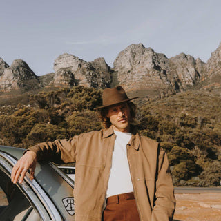 Man in Will & Bear Crushable Travel Hat standing in rocky outback landscape, styled for rugged travel