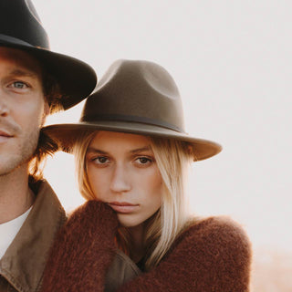 Man and woman wearing Will & Bear Crushable Travel Hats by the ocean, designed for all-season road adventures