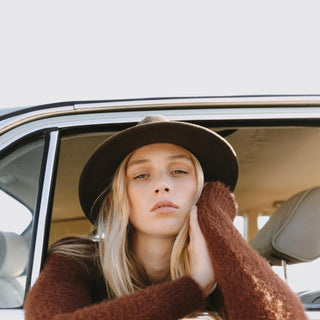 Woman leaning out car window wearing William Brown wide-brim soft wool fedora