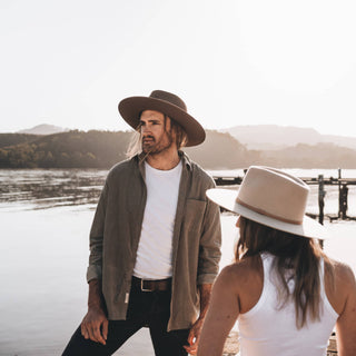 Couple by the waterfront wearing Will & Bear Andy Auburn Dark Brown Country Hat, crafted for timeless outdoor moments