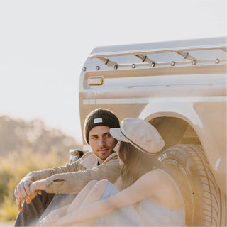 Laidback road trip moment featuring woman in Will & Bear Aus Wool Beanie, ready for outdoor adventures