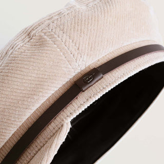 Close-up detail of Will & Bear Baker Fawn cap showing white corduroy texture and brown accent band.