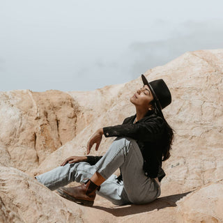 Woman wearing Will & Bear Black Wide Brim Hat, embracing outdoor adventure lifestyle