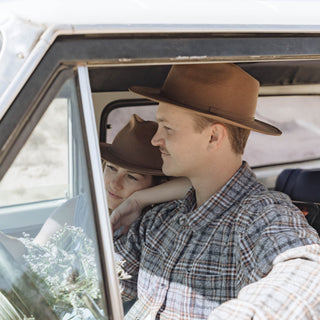 Road trip moment with man wearing Will & Bear Brown Wide Brim Fedora, captured through open window