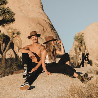 Man relaxing in nature wearing Will & Bear Brown Wide Brim Fedora, ideal for outdoor adventures