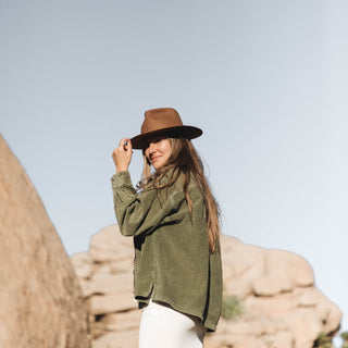 Woman enjoying sunshine in Will & Bear Brown Wide Brim Fedora, crafted for sustainable adventures