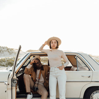 Couple road-tripping in coastal sunshine wearing the Will & Bear Calloway Cream white sun felt hat.