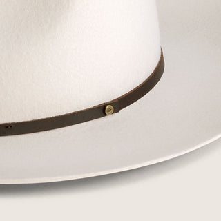 Close-up detail of the Will & Bear Cooper Bone White Upturned Fedora’s leather band and raw edge brim.