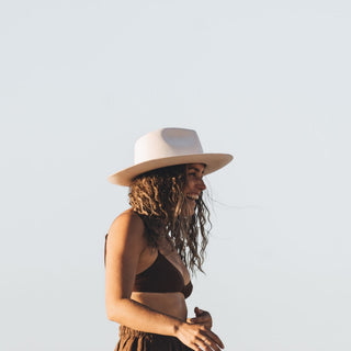 Woman wearing the Will & Bear Cooper Bone White Upturned Fedora outdoors, styled for warm-weather adventure.

