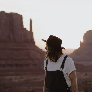 Man at sunset in a desert landscape wearing the Will & Bear Cooper Coffee Brown Western Hat.