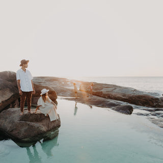 Couple exploring rock pools at sunrise, the man wearing the Will & Bear Cooper Coffee Brown Western Hat.