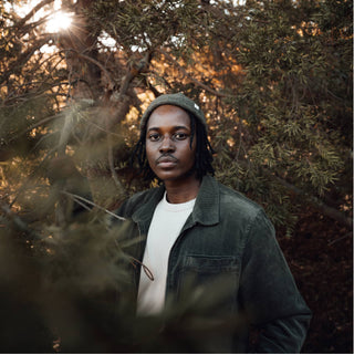 Man wearing Will & Bear Forest Green Beanie – Tasman Moss – deep green wool beanie built for comfort and connection to nature.