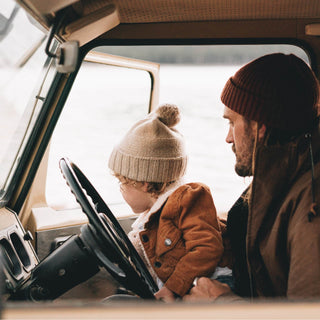 Toddler Wearing Will & Bear Little Tasman Fawn Kids Wool Cream Beanie – Natural Wool for Family Road Trips.