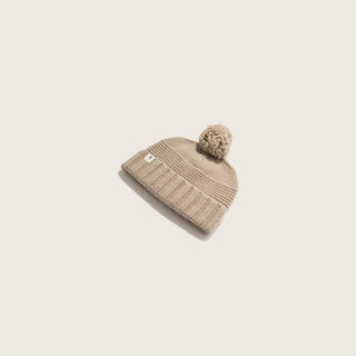 Top View of Will & Bear Little Tasman Fawn Kids Wool Cream Beanie – Ribbed Knit Wool Beanie with Pom Pom on Neutral Background.